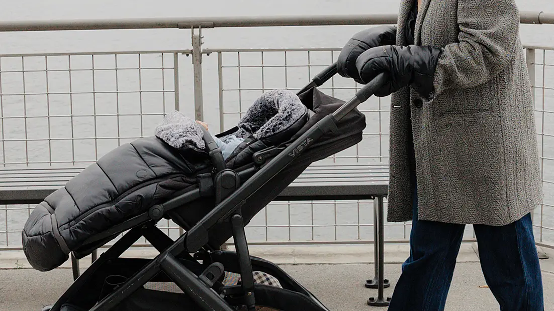 Pushing stroller with CozyHandmuffs
